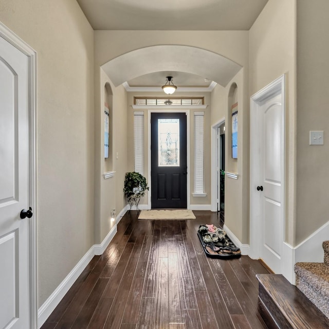 foyer entrance featuring dark hardwood / wood-style floors and ornamental molding