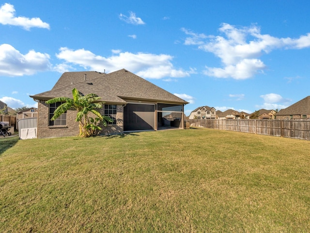 rear view of property featuring a yard