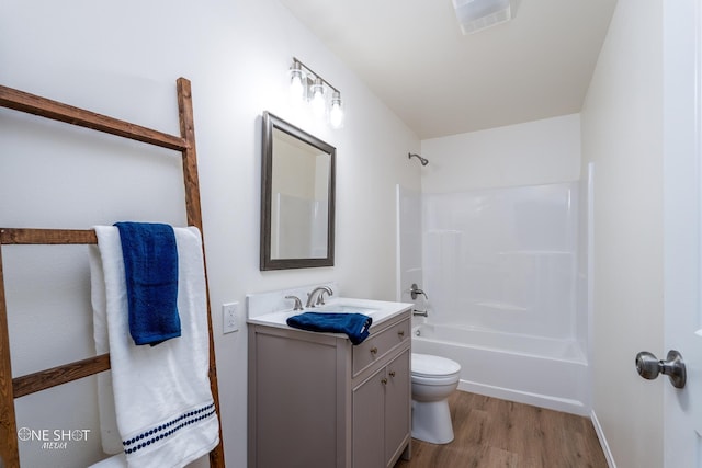 full bathroom featuring  shower combination, wood-type flooring, toilet, and vanity