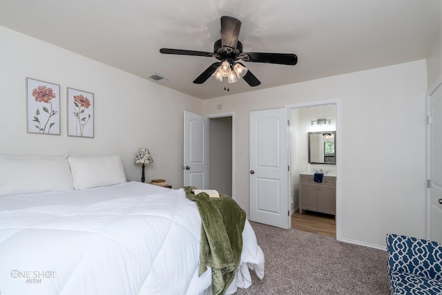 carpeted bedroom featuring connected bathroom and ceiling fan