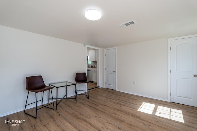 sitting room featuring light hardwood / wood-style floors