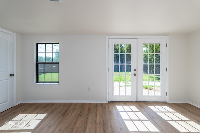 doorway to outside with light hardwood / wood-style flooring and french doors