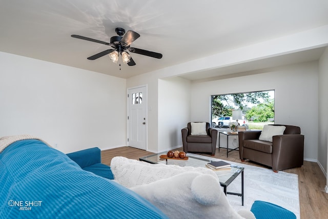 living room with light wood-type flooring and ceiling fan