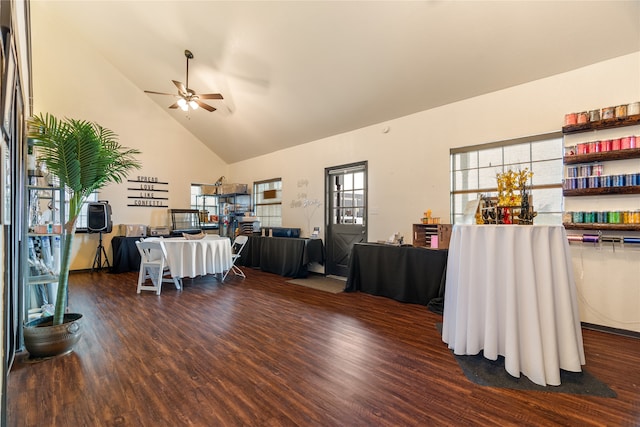 living room featuring dark hardwood / wood-style flooring, high vaulted ceiling, and ceiling fan