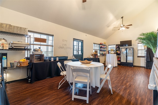 dining room featuring dark hardwood / wood-style flooring, high vaulted ceiling, and ceiling fan