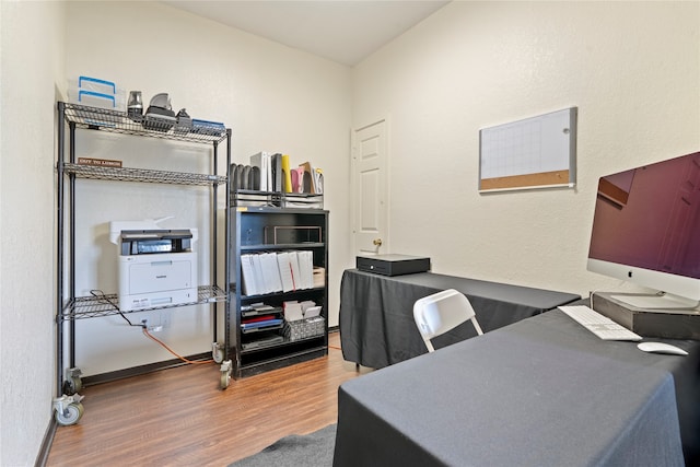 home office with hardwood / wood-style flooring