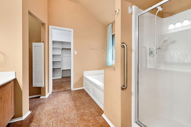 bathroom with vaulted ceiling, vanity, separate shower and tub, and tile patterned floors