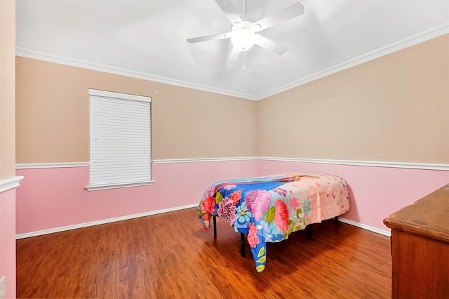 bedroom with ornamental molding, hardwood / wood-style floors, and ceiling fan