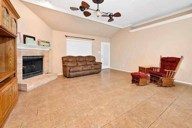 tiled living room featuring crown molding, ceiling fan, lofted ceiling, and a fireplace