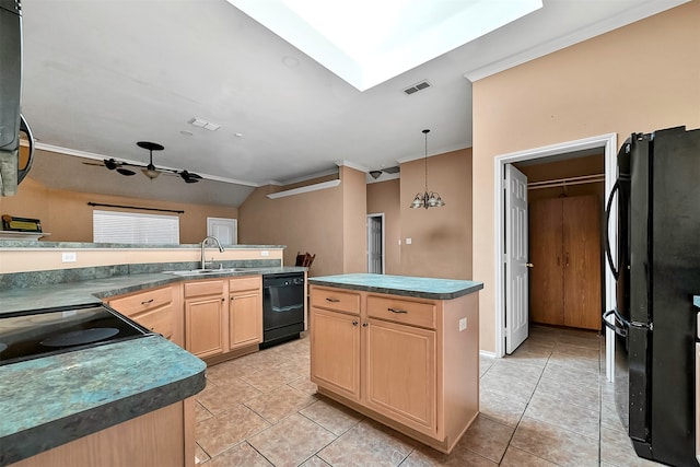 kitchen featuring a center island, black appliances, sink, vaulted ceiling with skylight, and light brown cabinetry