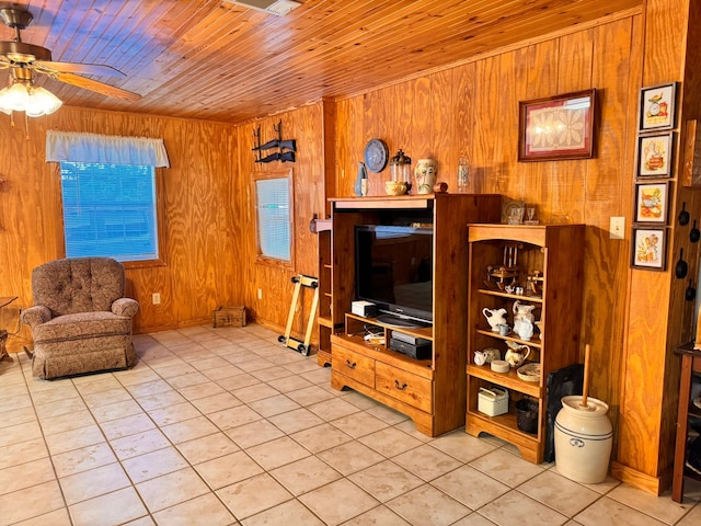 living room with wood walls, light tile patterned flooring, and wood ceiling