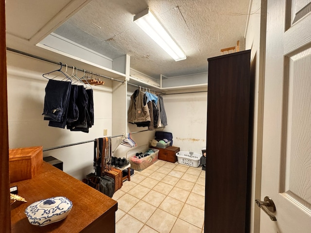 walk in closet with tile patterned floors