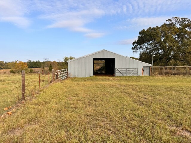 view of outdoor structure featuring a yard and a rural view