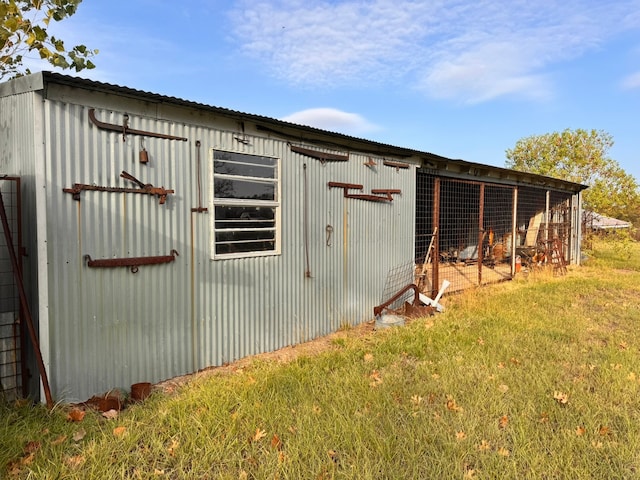 view of outbuilding with a yard