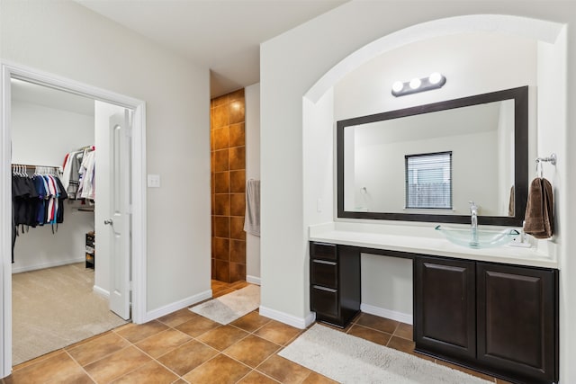 bathroom with vanity, walk in shower, and tile patterned floors