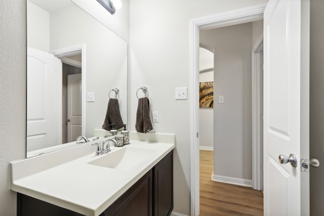 bathroom featuring vanity and hardwood / wood-style flooring