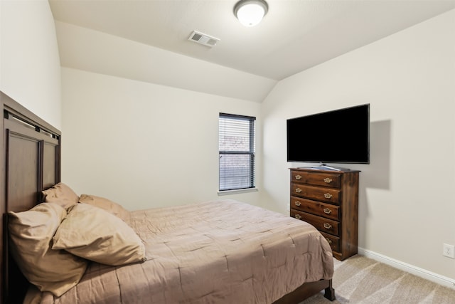 carpeted bedroom featuring vaulted ceiling