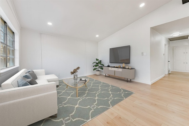 living area with lofted ceiling, baseboards, recessed lighting, and wood finished floors