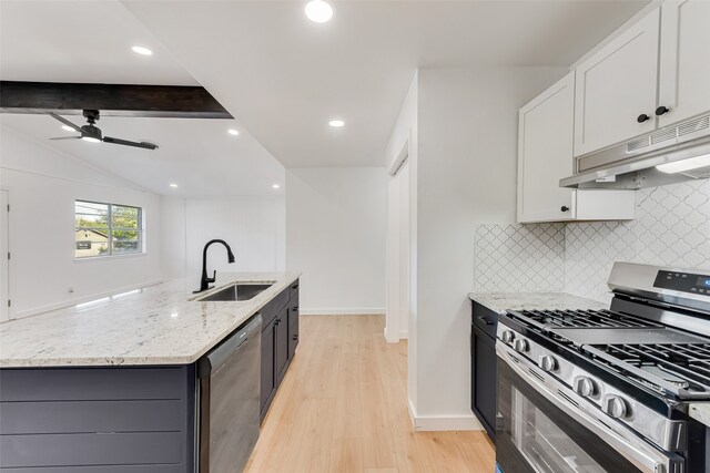 kitchen with a sink, ceiling fan, stainless steel gas range, under cabinet range hood, and dishwashing machine