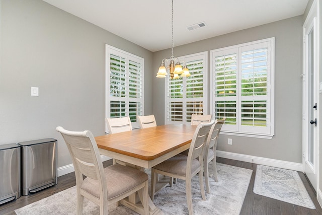 dining space featuring an inviting chandelier and wood-type flooring