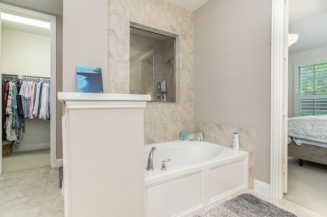 bathroom with tile patterned floors and separate shower and tub