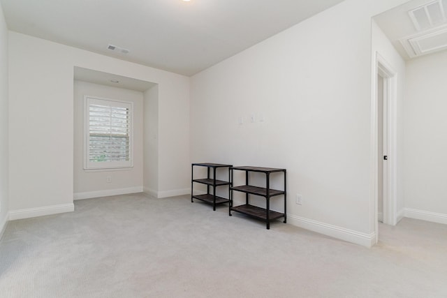 unfurnished room featuring light colored carpet