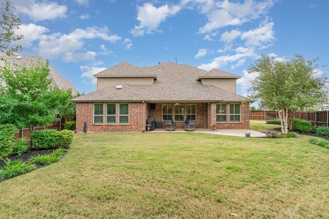 back of house with a patio and a lawn