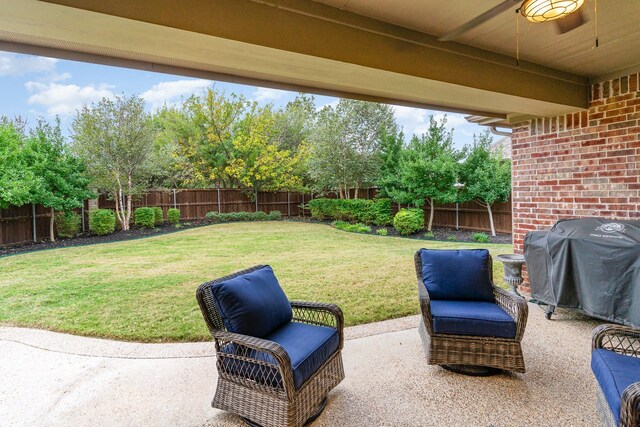 view of yard with ceiling fan and a patio area