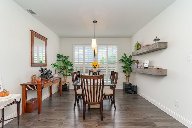 dining room with dark hardwood / wood-style flooring