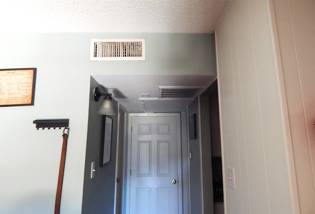 hallway featuring a textured ceiling