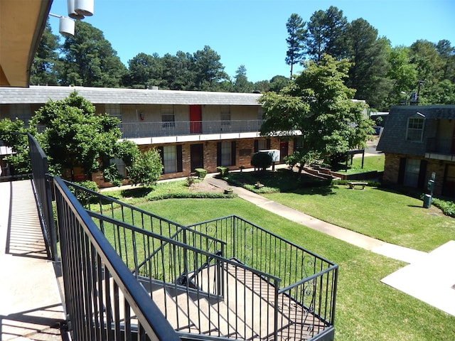 view of property's community with a lawn