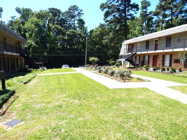 view of yard with a balcony