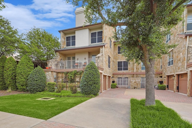 view of front of property with a balcony and a garage