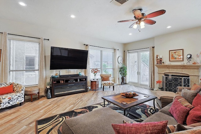 living room featuring hardwood / wood-style floors and ceiling fan