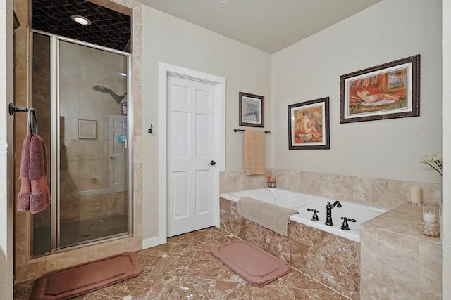 bathroom featuring separate shower and tub