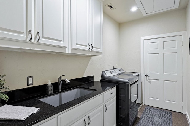 laundry area featuring sink, cabinets, and independent washer and dryer