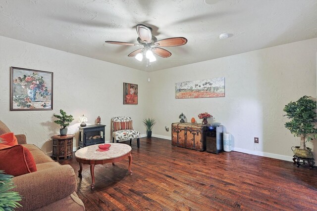 living room with dark wood-type flooring and ceiling fan