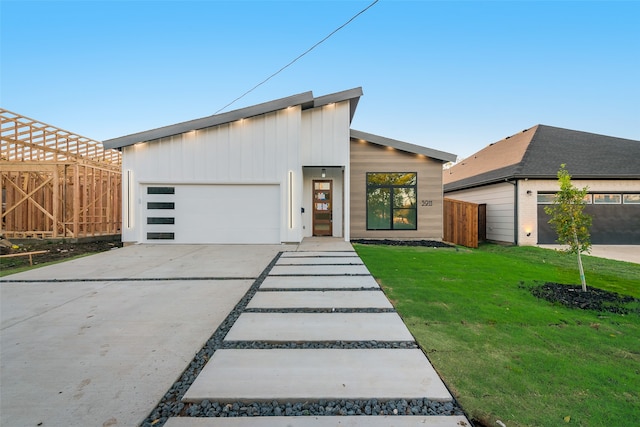 contemporary home featuring a garage and a front yard