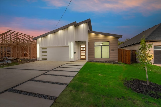 view of front of house with a garage and a lawn