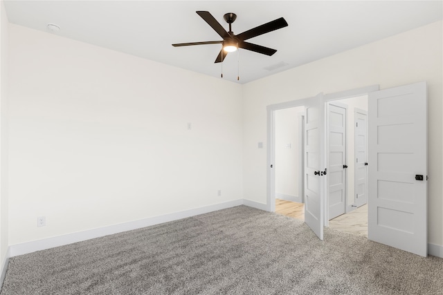 unfurnished bedroom with ceiling fan and light colored carpet