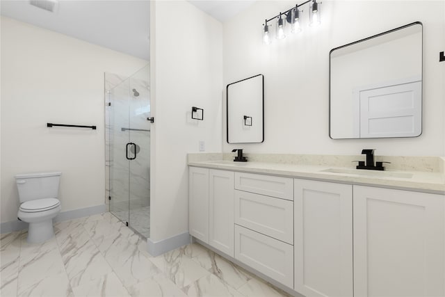 bathroom with vanity, toilet, and a shower with shower door