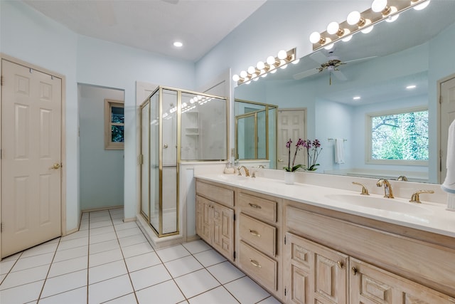 bathroom with walk in shower, vanity, tile patterned floors, and ceiling fan