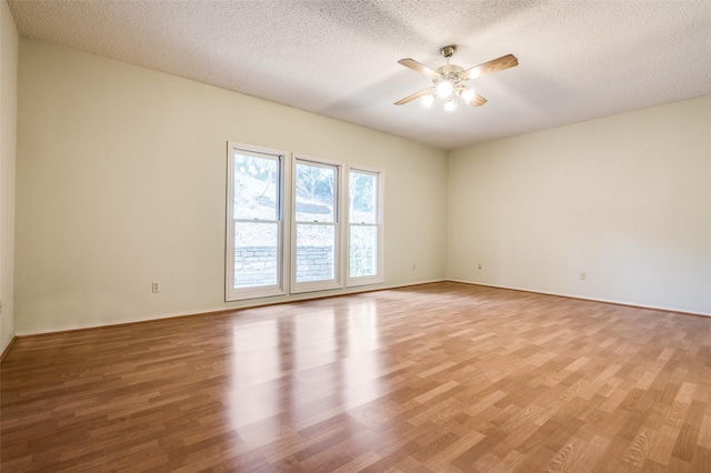 unfurnished room featuring light wood-type flooring, a textured ceiling, and ceiling fan