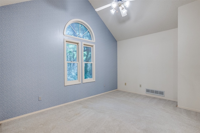 carpeted spare room with high vaulted ceiling and ceiling fan