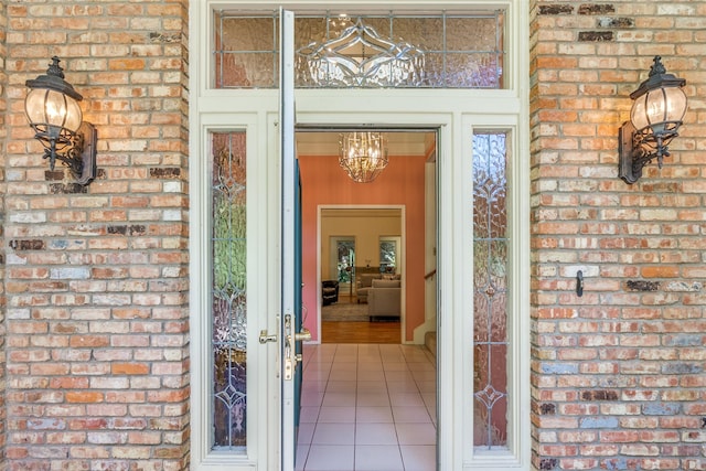 view of exterior entry with brick siding