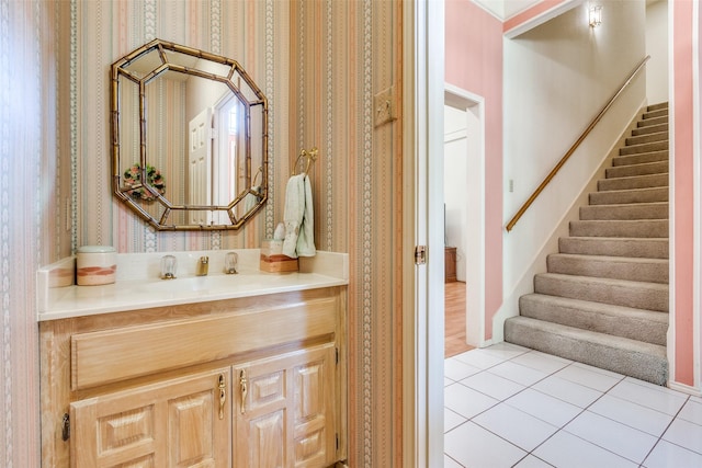 bathroom featuring vanity, tile patterned flooring, and wallpapered walls