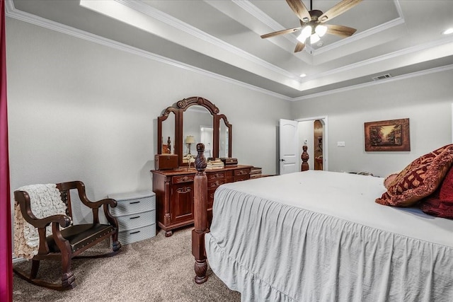 bedroom with ceiling fan, ornamental molding, a raised ceiling, and light carpet