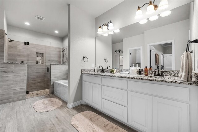 bathroom with vanity, hardwood / wood-style floors, and separate shower and tub