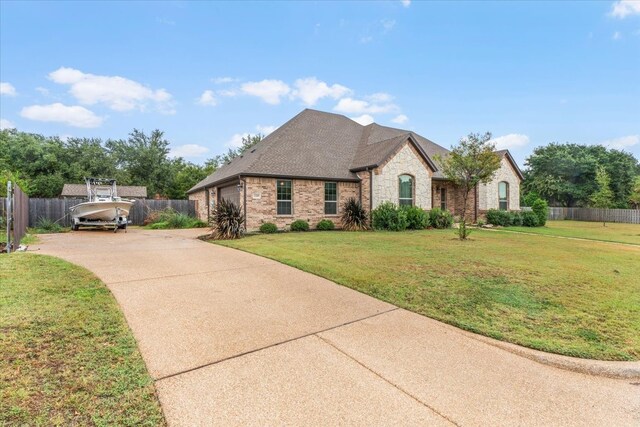 view of front of property featuring a garage and a front yard