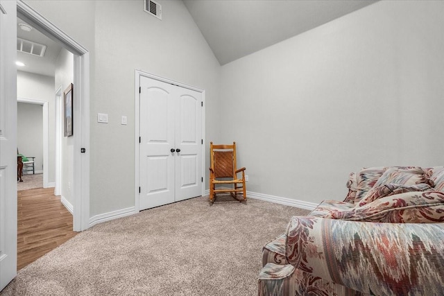 sitting room with lofted ceiling and carpet